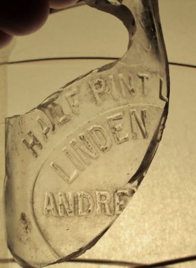 Part of a 1/2 pint bottle found under an old barn.