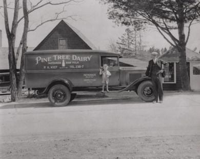 Percy Kief with son Lawrence in front of delivery truck, 1931