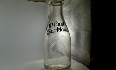 Unusual bottle with black pyro lettering on one side.